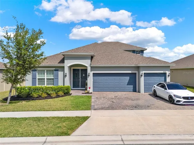 a car parked in front of white house
