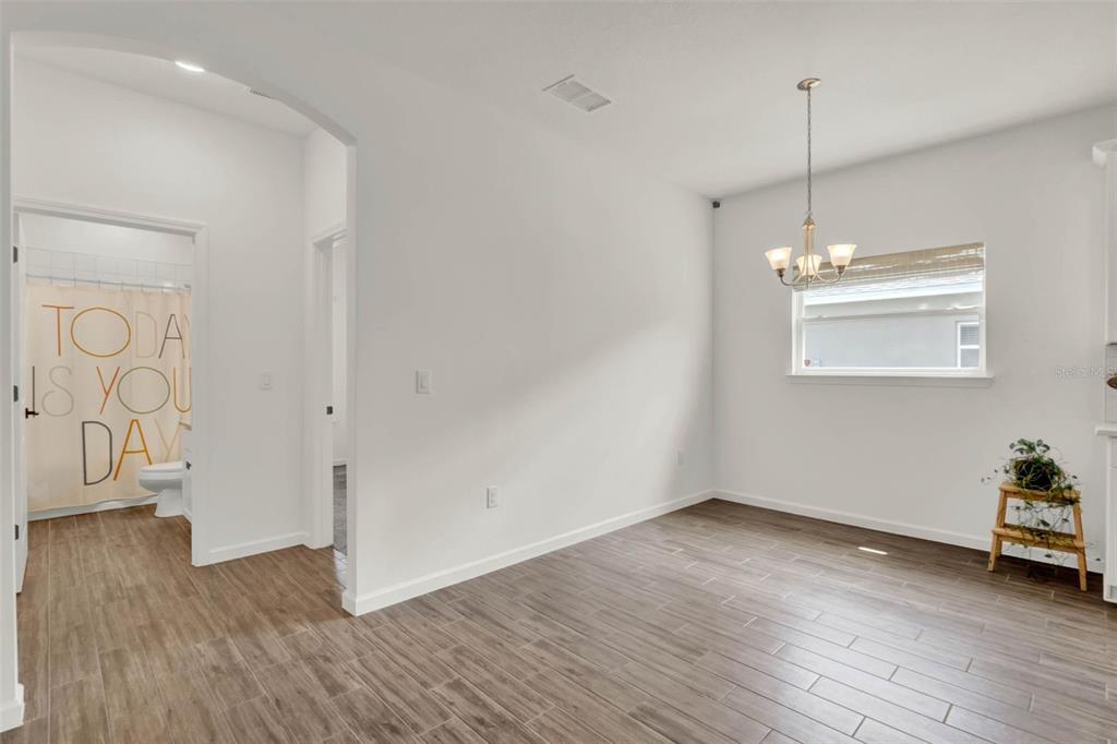 533 Avila Place Howey-in-the-Hills, FL 34737 - Photo 16 of 42 a view of an empty room with wooden floor and a window
