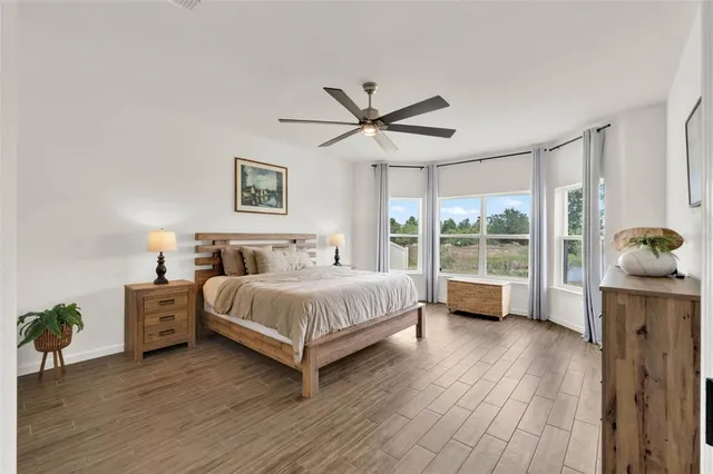 a spacious bedroom with a bed and a window