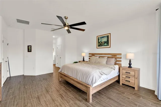 a bedroom with a bed and a chandelier