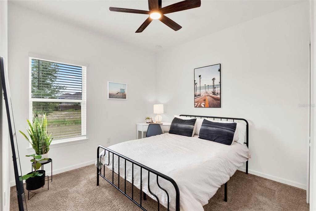 533 Avila Place Howey-in-the-Hills, FL 34737 - Photo 20 of 42 a bedroom with a large bed and a window