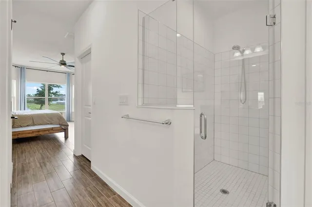 a bathroom with a granite countertop toilet sink and mirror