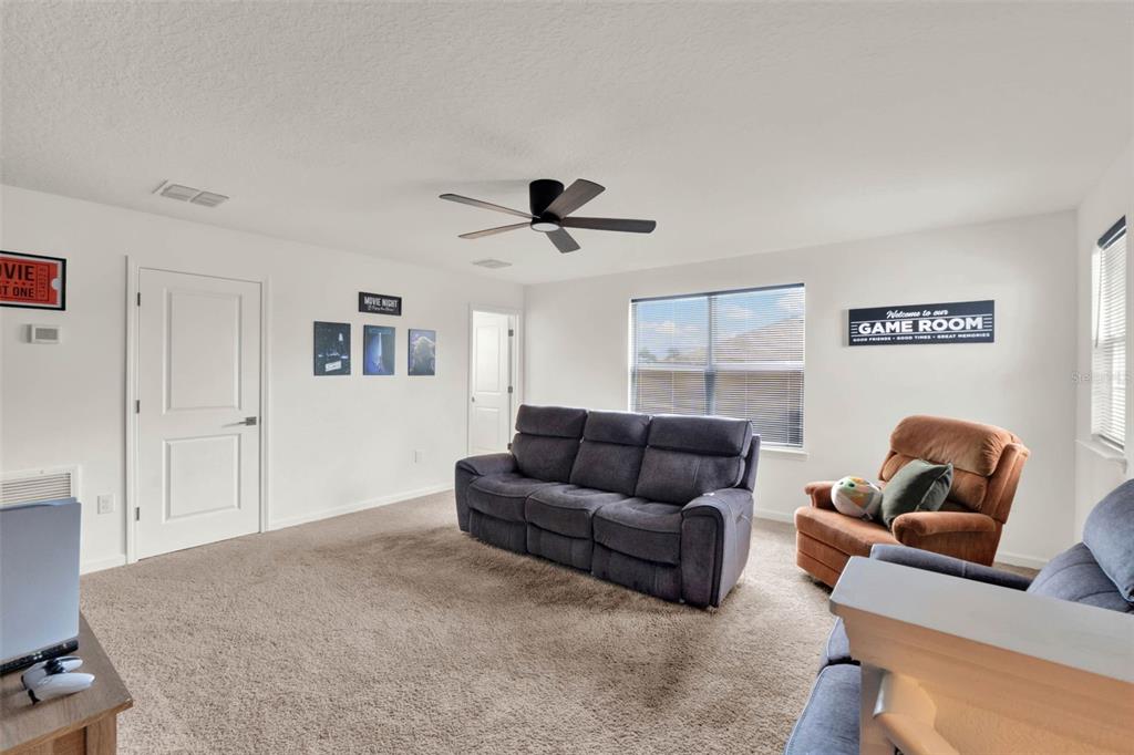 533 Avila Place Howey-in-the-Hills, FL 34737 - Photo 32 of 42 a living room with furniture and a ceiling fan