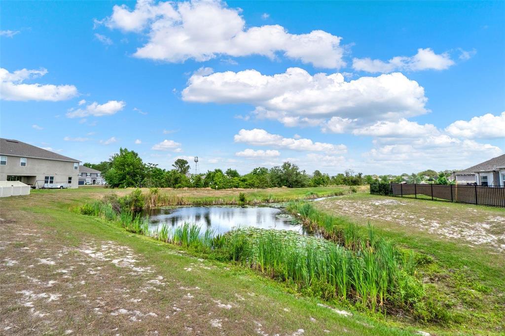533 Avila Place Howey-in-the-Hills, FL 34737 - Photo 36 of 42 a view of a lake with houses in the back