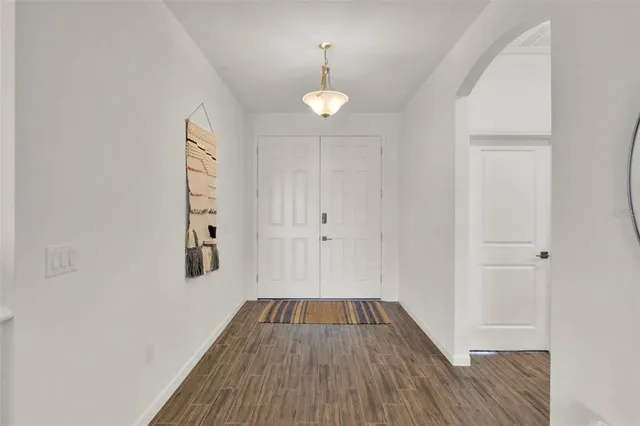 a view of a room with wooden floor window and a ceiling fan