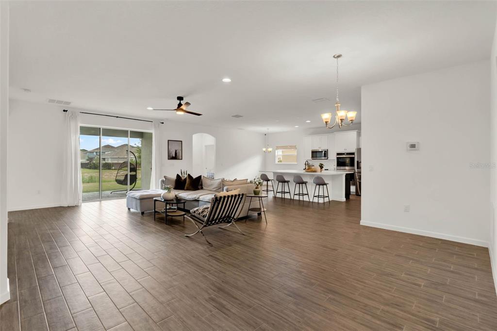 533 Avila Place Howey-in-the-Hills, FL 34737 - Photo 6 of 42 a living room with furniture and a wooden floor