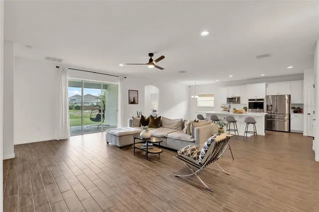 a living room with furniture or wooden floor and a large window
