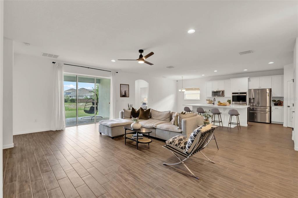533 Avila Place Howey-in-the-Hills, FL 34737 - Photo 8 of 42 a living room with furniture or wooden floor and a large window