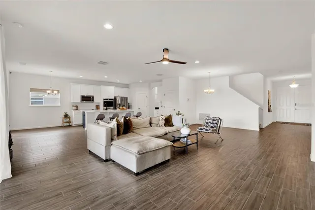 a living room with furniture and wooden floor