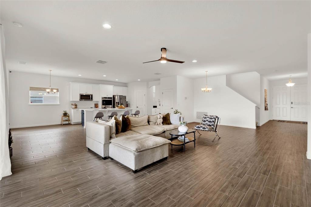 533 Avila Place Howey-in-the-Hills, FL 34737 - Photo 9 of 42 a living room with furniture and wooden floor