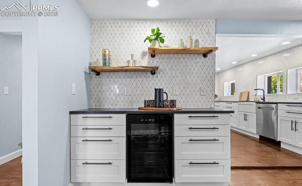 29767 Preston Road Pueblo, CO 81006 - Photo 14 of 50 a kitchen with stainless steel appliances cabinets and a wooden floor