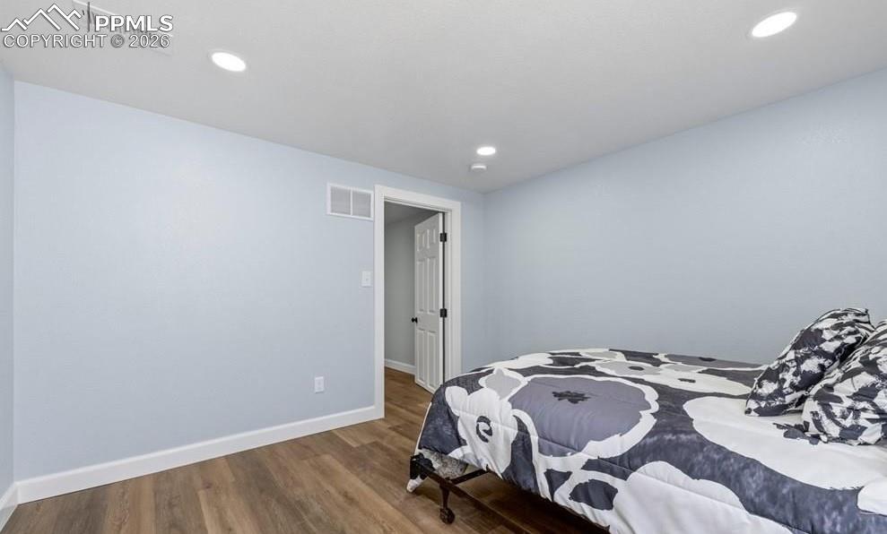 29767 Preston Road Pueblo, CO 81006 - Photo 40 of 50 a bedroom with a bed and wooden floor
