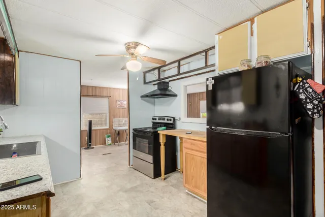 a kitchen with stainless steel appliances granite countertop a refrigerator and a stove top oven