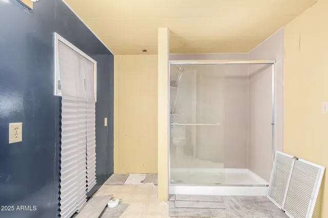 a bathroom with a glass shower door