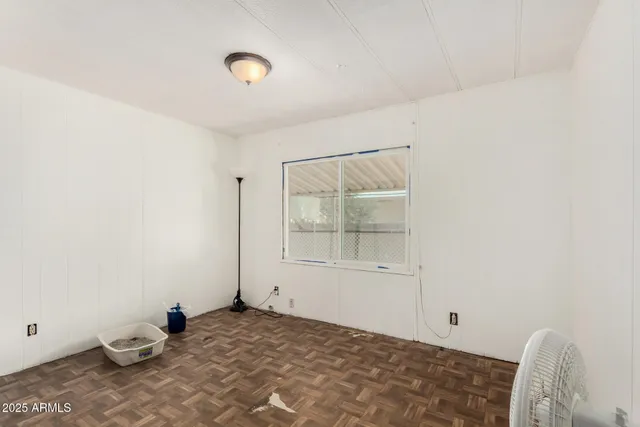 a view of a room with wooden floor and window