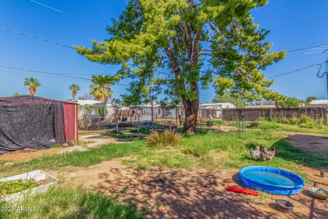 a backyard of a house with a garden and outdoor seating