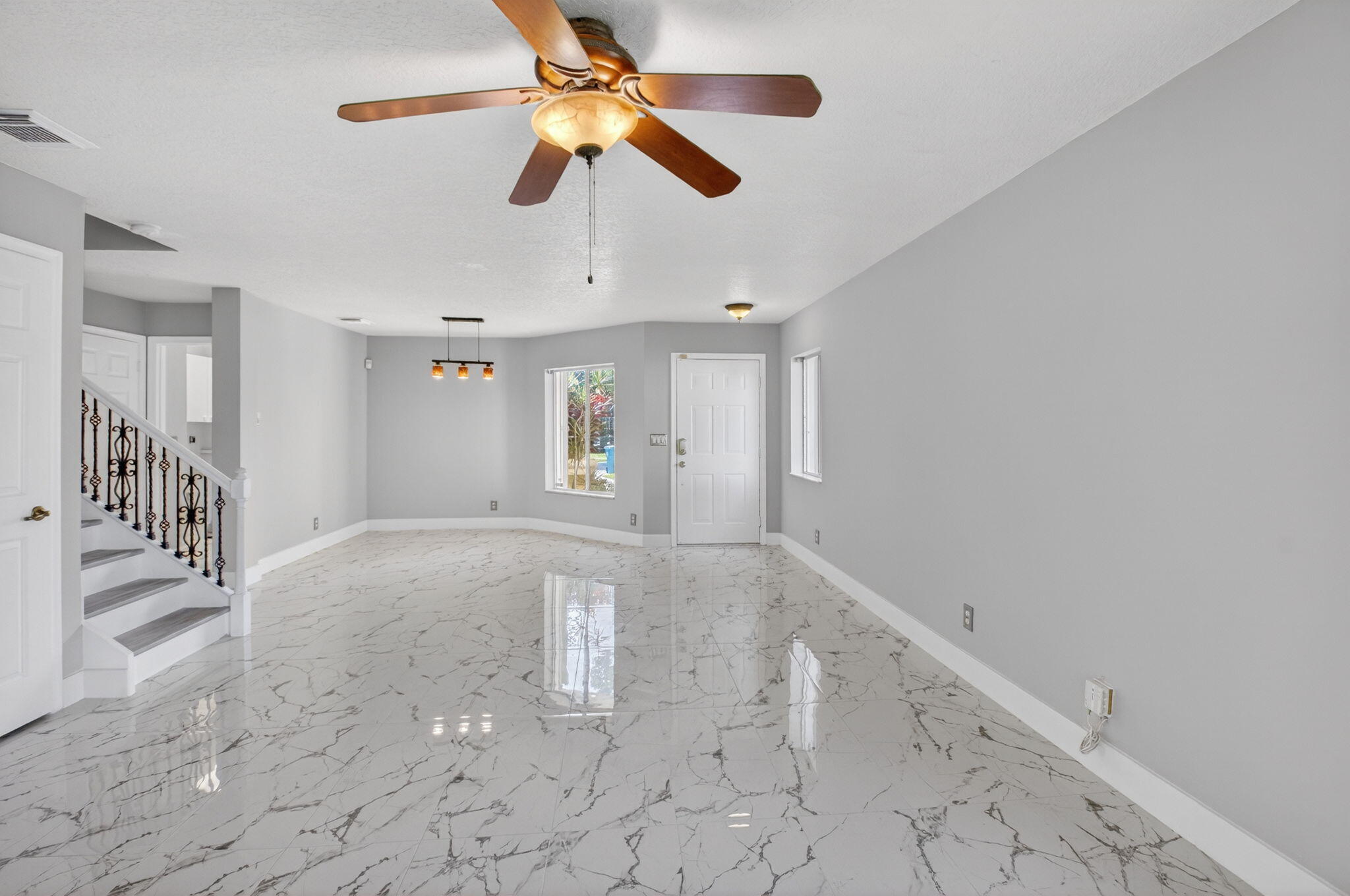 1728 Arezzo Circle Boynton Beach, FL 33436 - Photo 12 of 66 en empty room with windows and ceiling fan