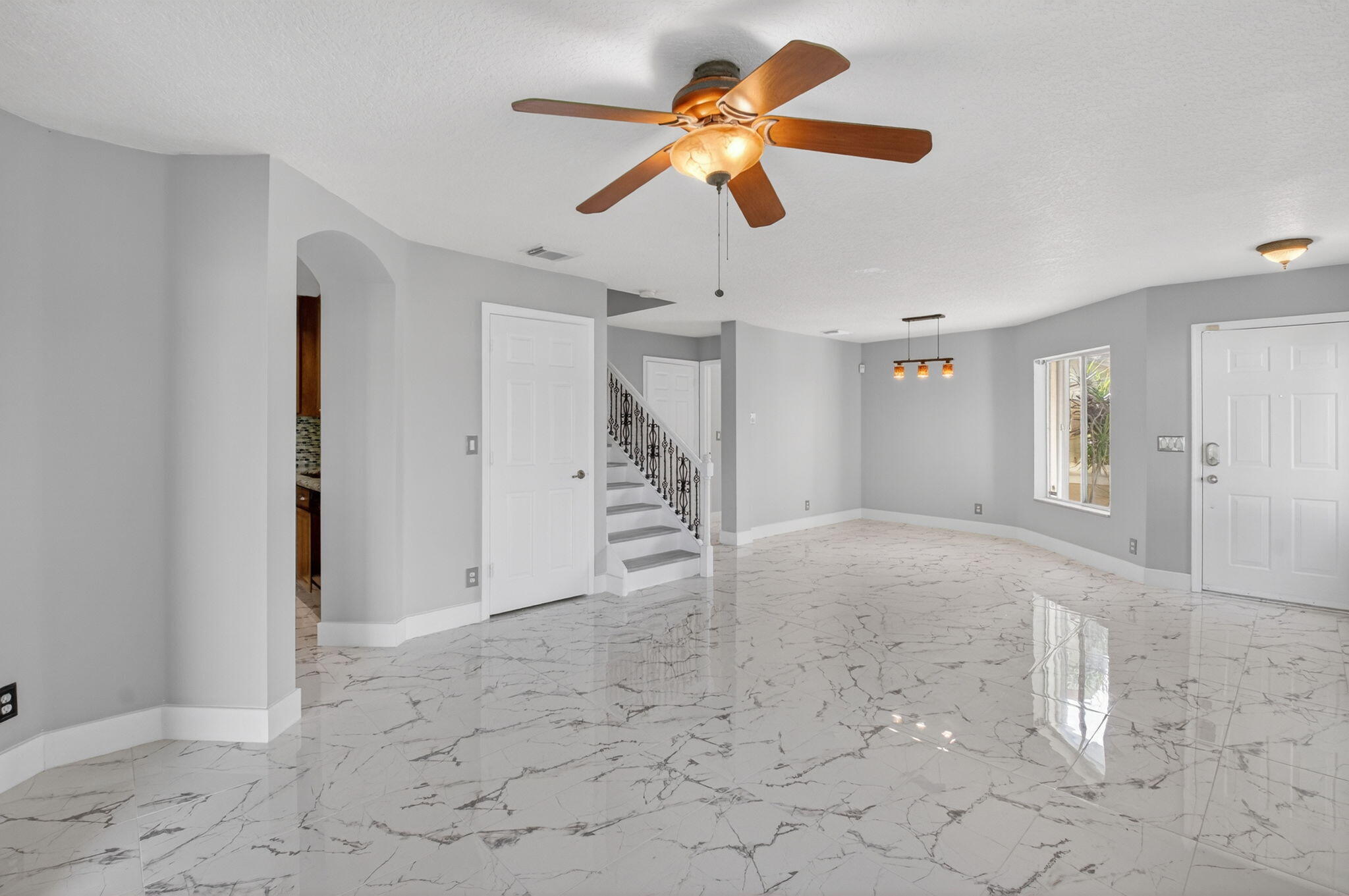1728 Arezzo Circle Boynton Beach, FL 33436 - Photo 13 of 66 a view of an empty room with a ceiling fan