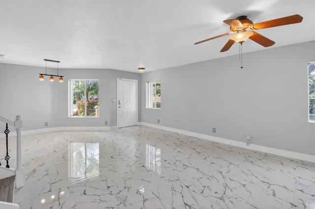 a view of a livingroom with a ceiling fan and a window