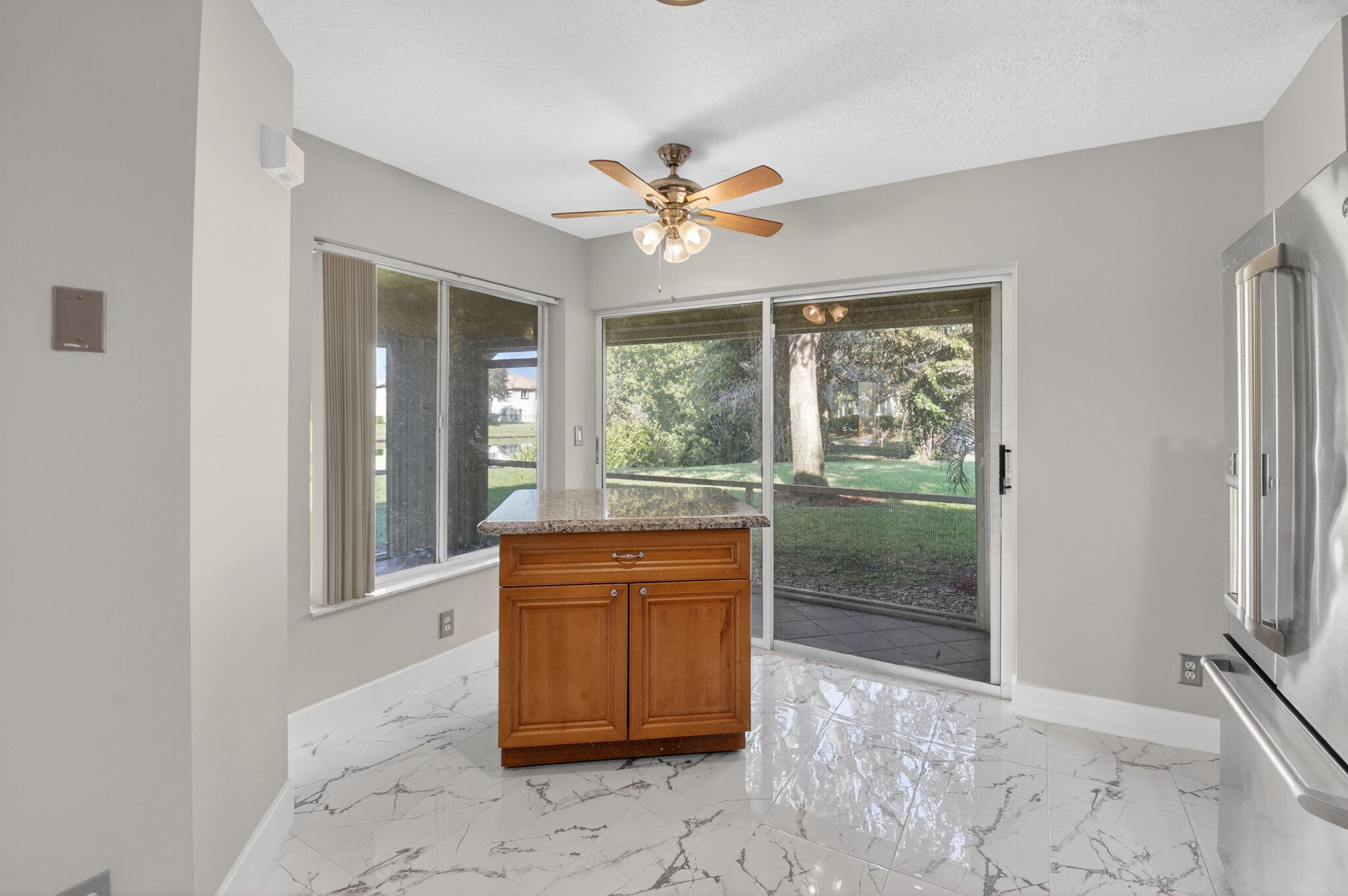 1728 Arezzo Circle Boynton Beach, FL 33436 - Photo 16 of 66 a view of a livingroom with a ceiling fan and a window
