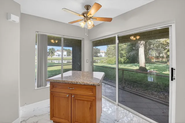 a bathroom with a granite countertop sink a mirror and vanity