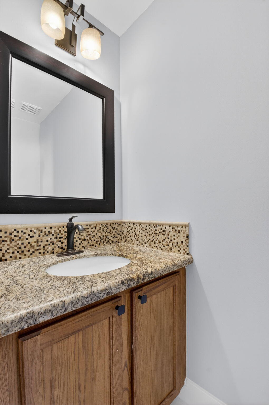 1728 Arezzo Circle Boynton Beach, FL 33436 - Photo 22 of 66 a bathroom with a granite countertop sink a mirror and vanity