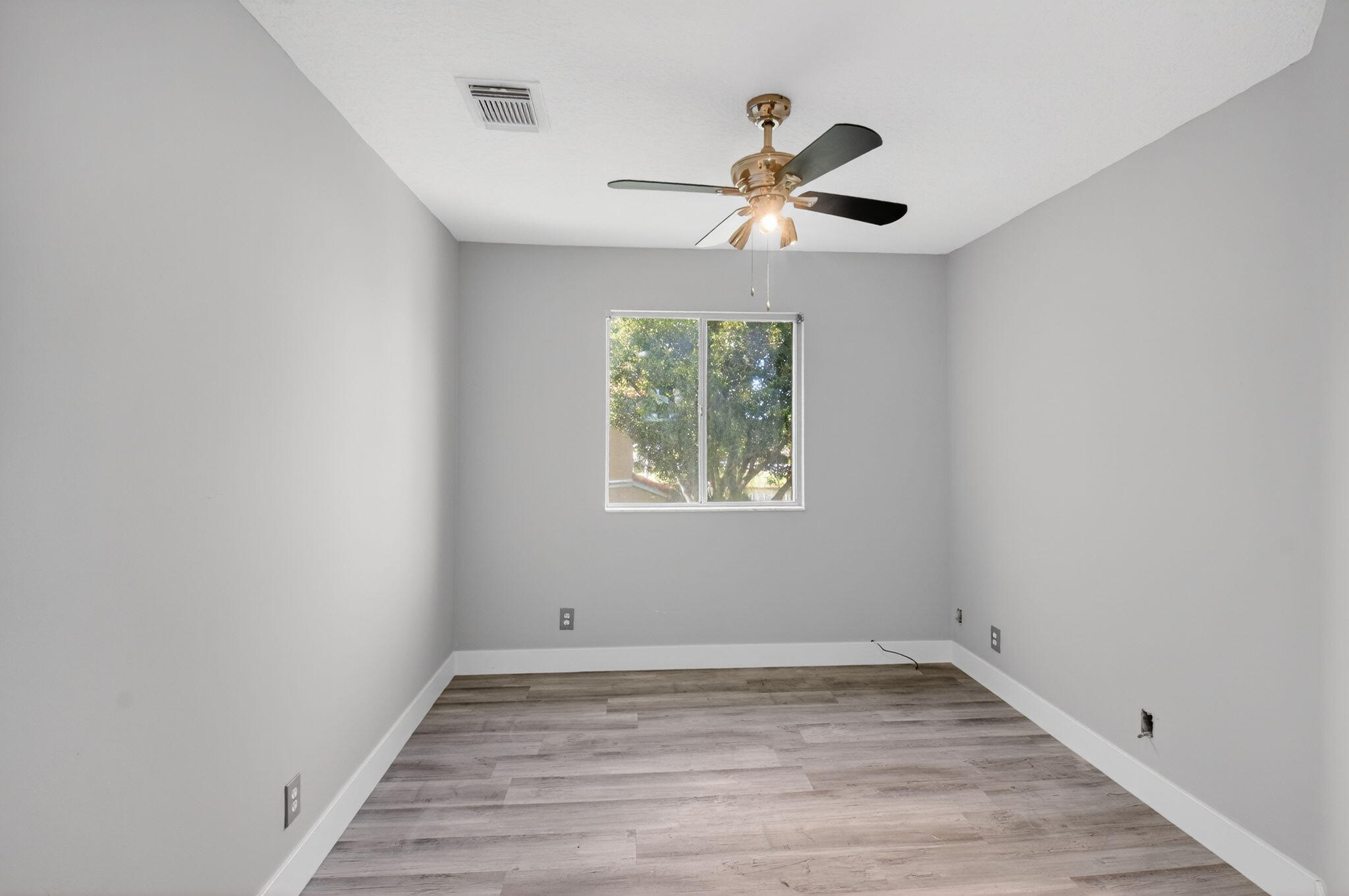 1728 Arezzo Circle Boynton Beach, FL 33436 - Photo 24 of 66 a view of empty room with wooden floor and fan