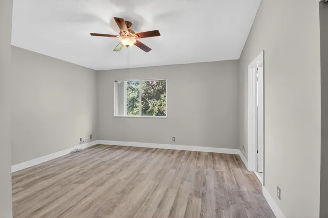 a view of a room with wooden floor