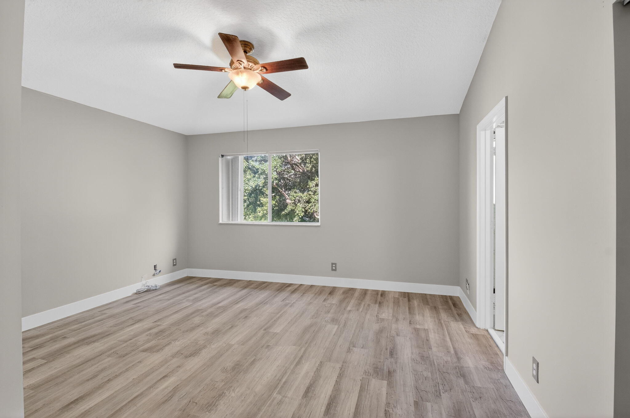 1728 Arezzo Circle Boynton Beach, FL 33436 - Photo 26 of 66 an empty room with wooden floor and ceiling fan