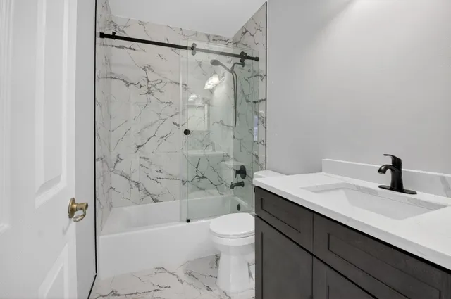 an aerial view of residential houses with outdoor space and trees all around