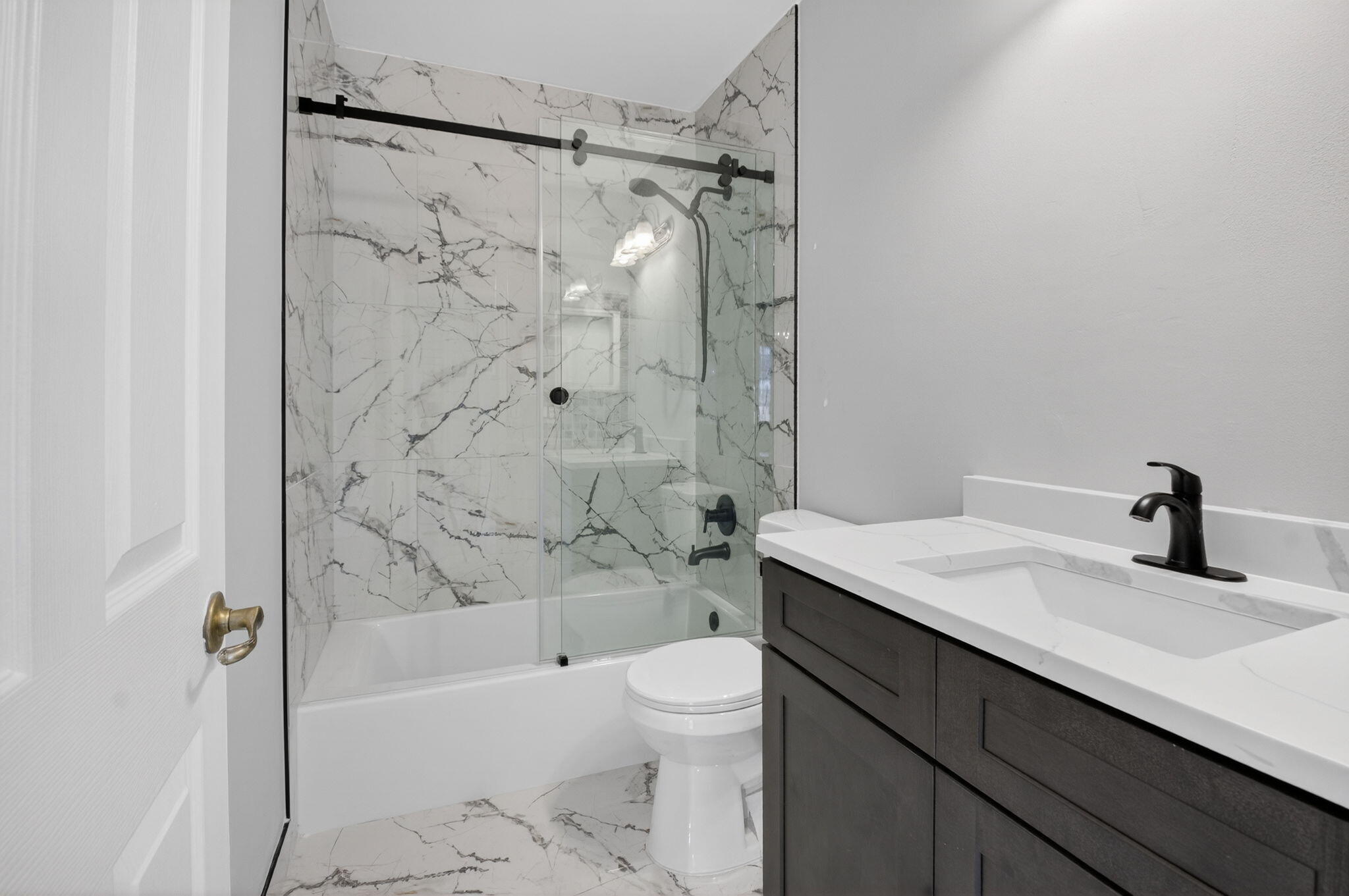 1728 Arezzo Circle Boynton Beach, FL 33436 - Photo 33 of 66 a bathroom with a granite countertop sink a toilet and shower