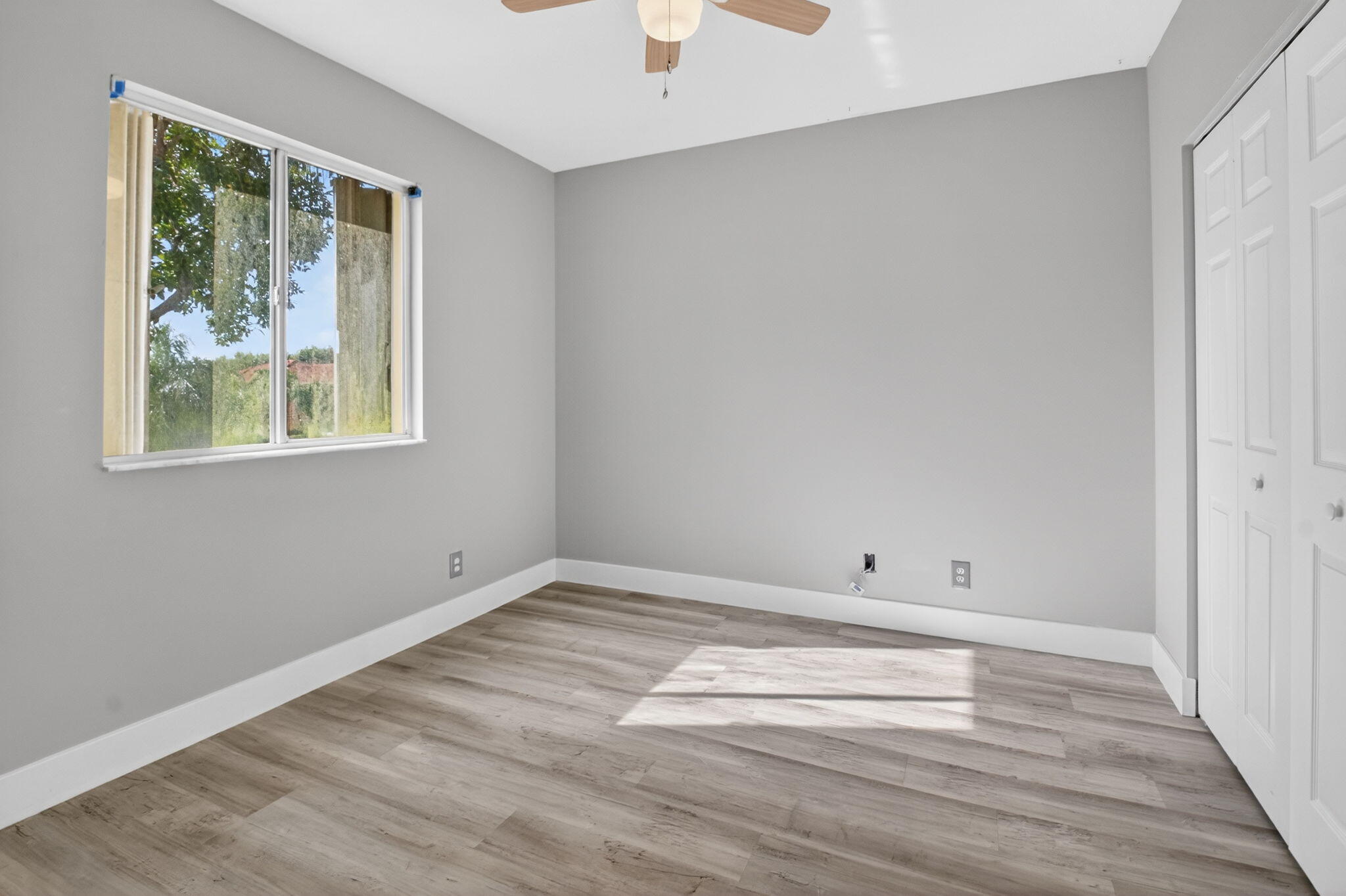 1728 Arezzo Circle Boynton Beach, FL 33436 - Photo 35 of 66 a view of empty room with wooden floor and fan