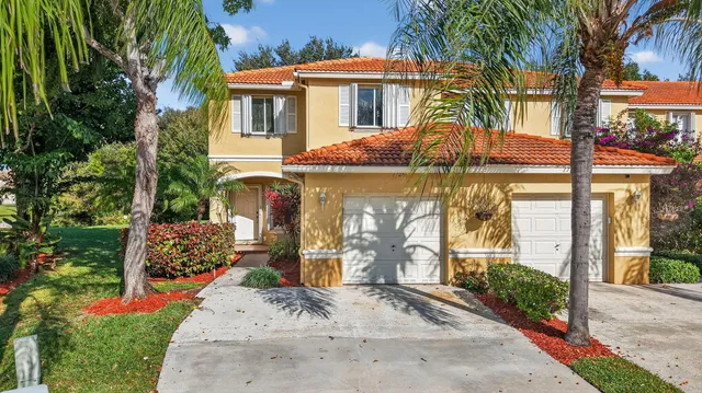 an aerial view of a swimming pool a yard and outdoor seating
