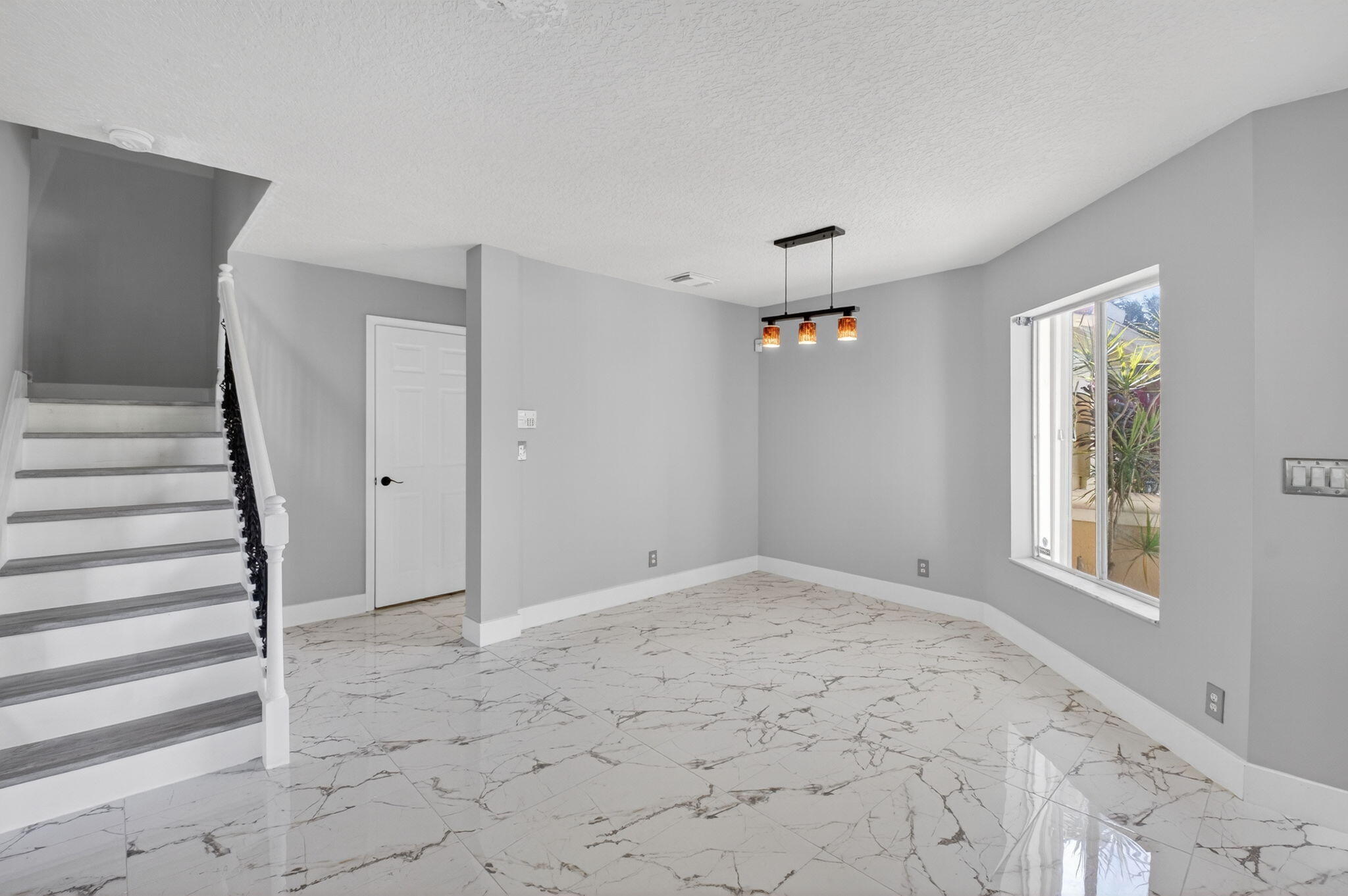 1728 Arezzo Circle Boynton Beach, FL 33436 - Photo 7 of 66 a view of an empty room with stairs and a window