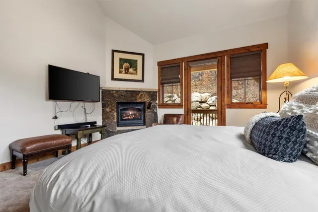 a bedroom with a bed and a television