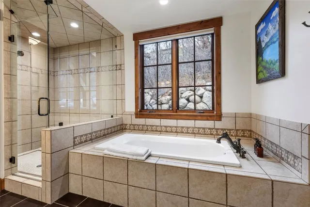 a bathroom with a bathtub and next to a window