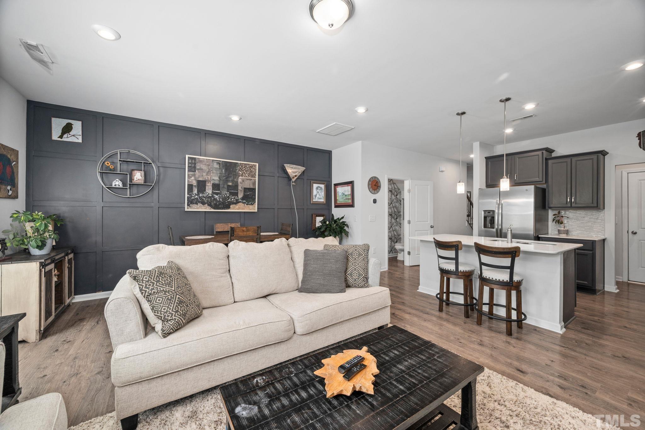 3614 Water Mist Lane Raleigh, NC 27604 - Photo 11 of 50 a living room with furniture kitchen view and a dining table