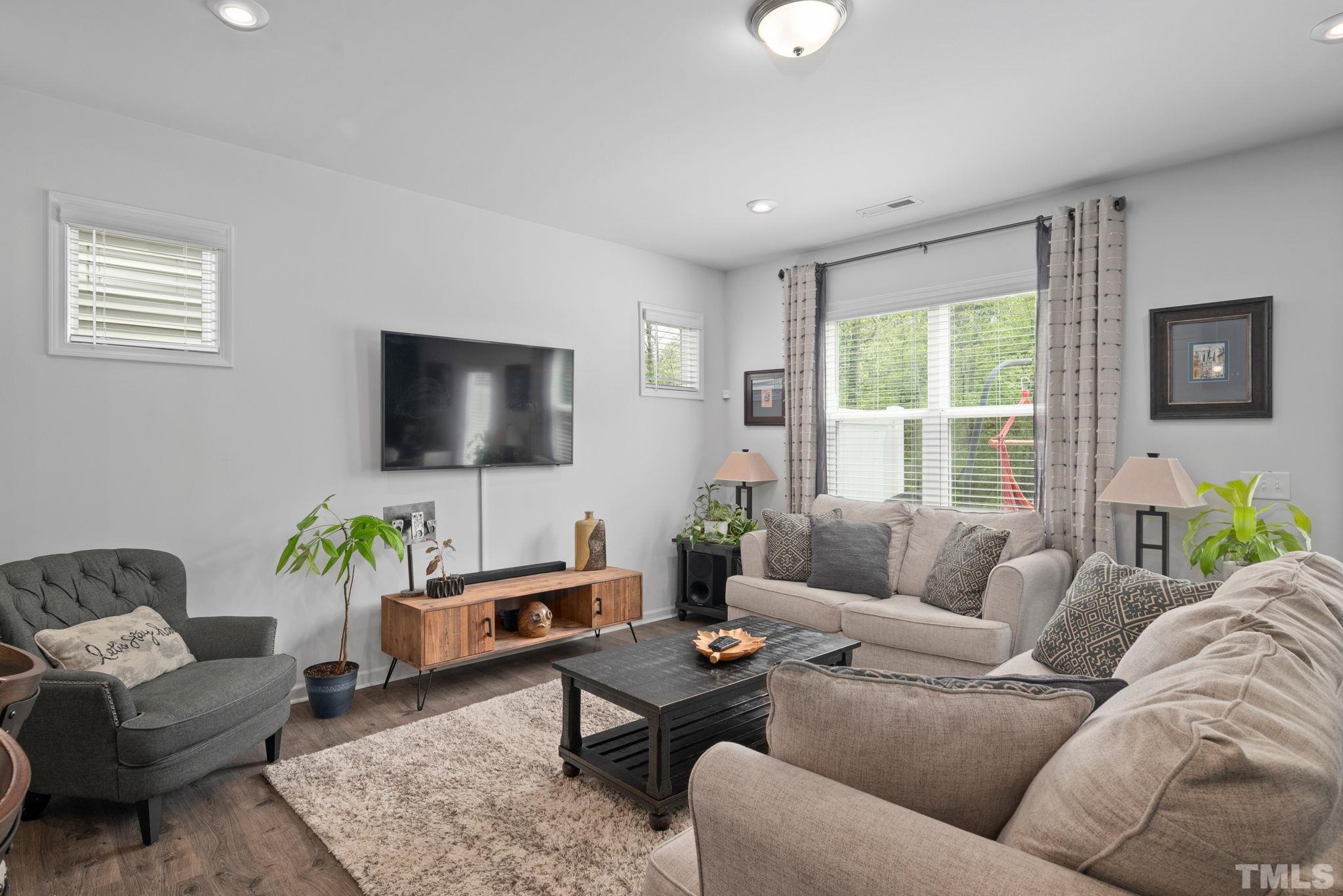 3614 Water Mist Lane Raleigh, NC 27604 - Photo 13 of 50 a living room with furniture and a flat screen tv