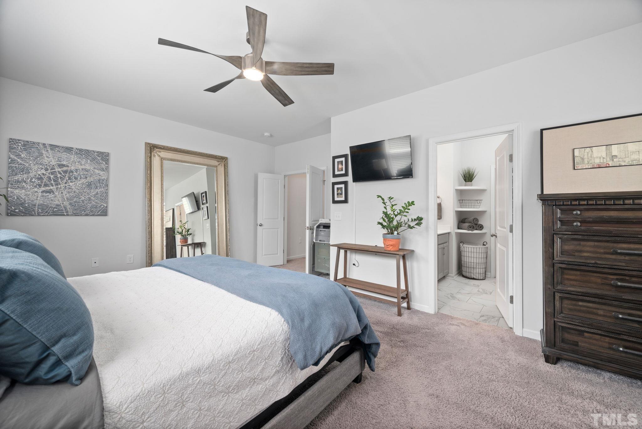 3614 Water Mist Lane Raleigh, NC 27604 - Photo 20 of 50 a spacious bedroom with a bed a flat screen tv and a couch
