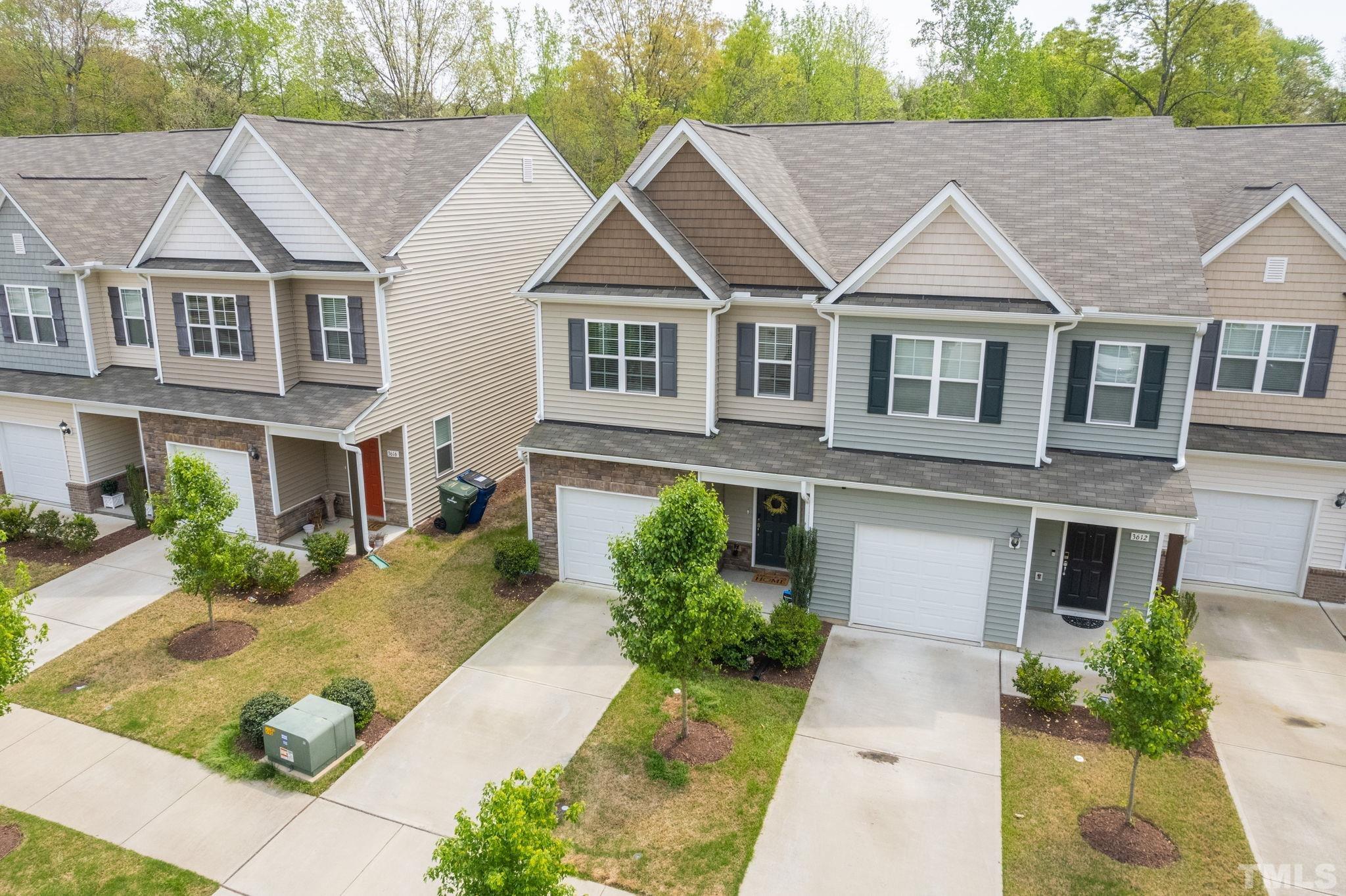 3614 Water Mist Lane Raleigh, NC 27604 - Photo 43 of 50 a view of a white house with large windows and a small yard