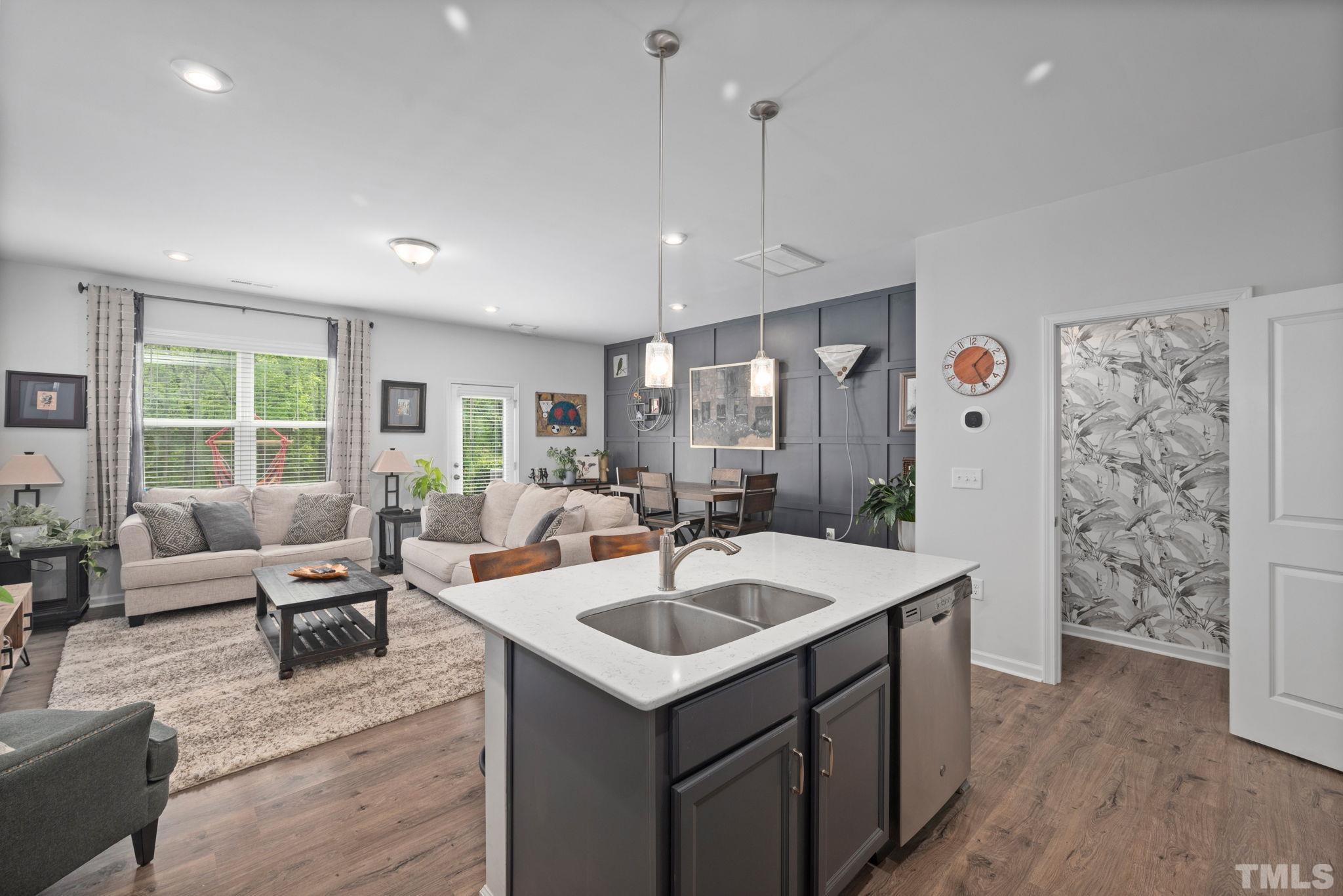 3614 Water Mist Lane Raleigh, NC 27604 - Photo 8 of 50 a view of living room kitchen with stainless steel appliances granite countertop a sink and living room view