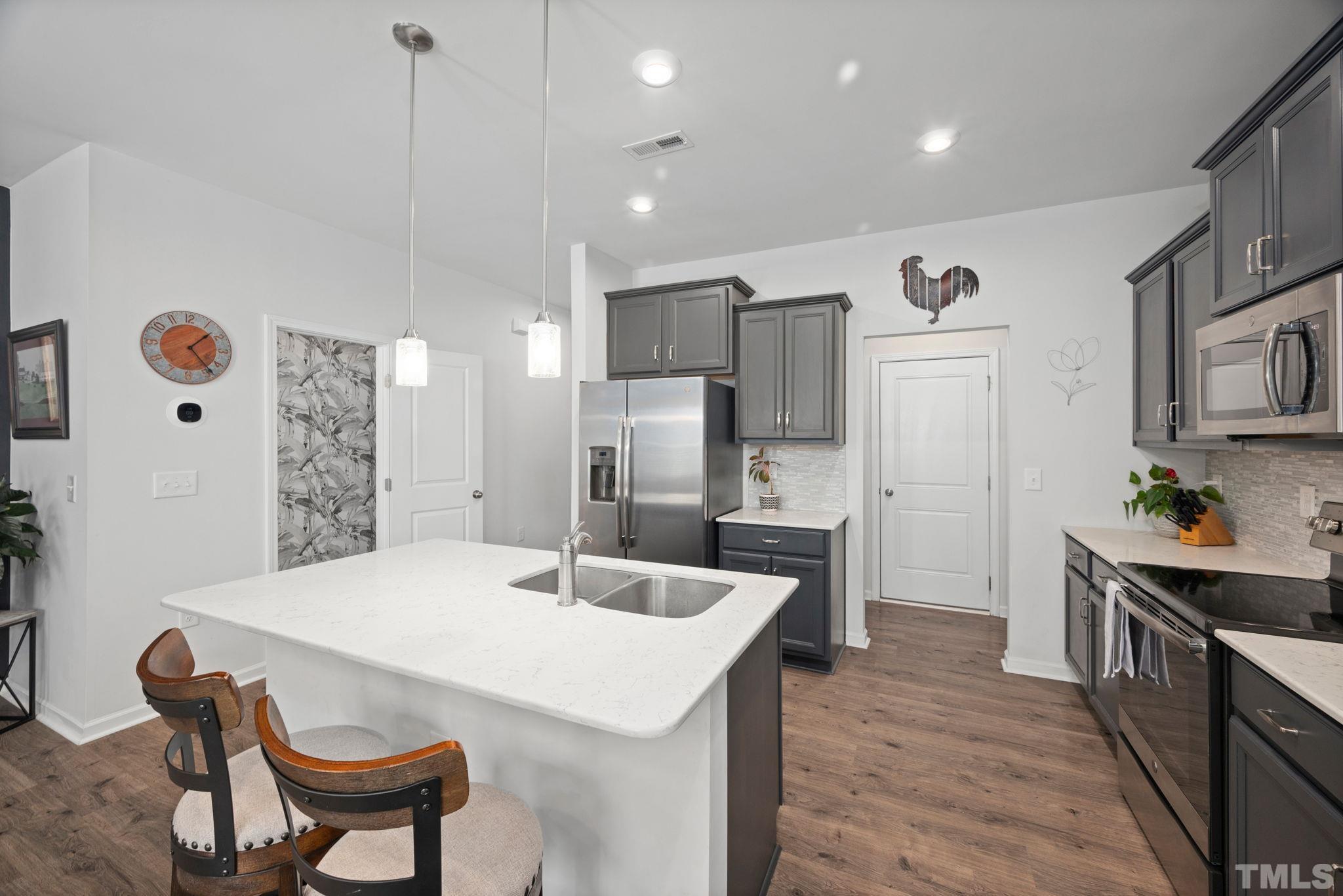 3614 Water Mist Lane Raleigh, NC 27604 - Photo 9 of 50 a kitchen with refrigerator and chairs