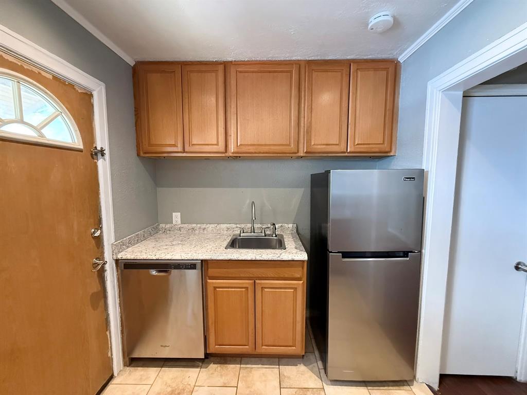 4610 Sycamore Street Dallas, TX 75204 - Photo 6 of 14 a kitchen with a refrigerator and cabinets