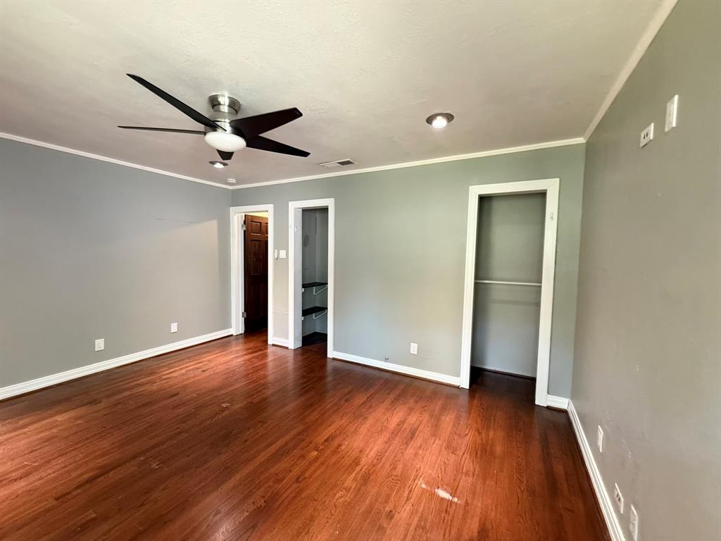 4610 Sycamore Street Dallas, TX 75204 - Photo 9 of 14 an empty room with wooden floor and a ceiling fan