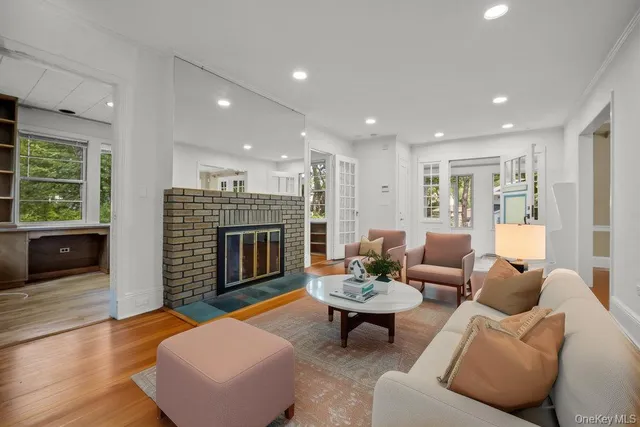 a living room with furniture a fireplace and a table