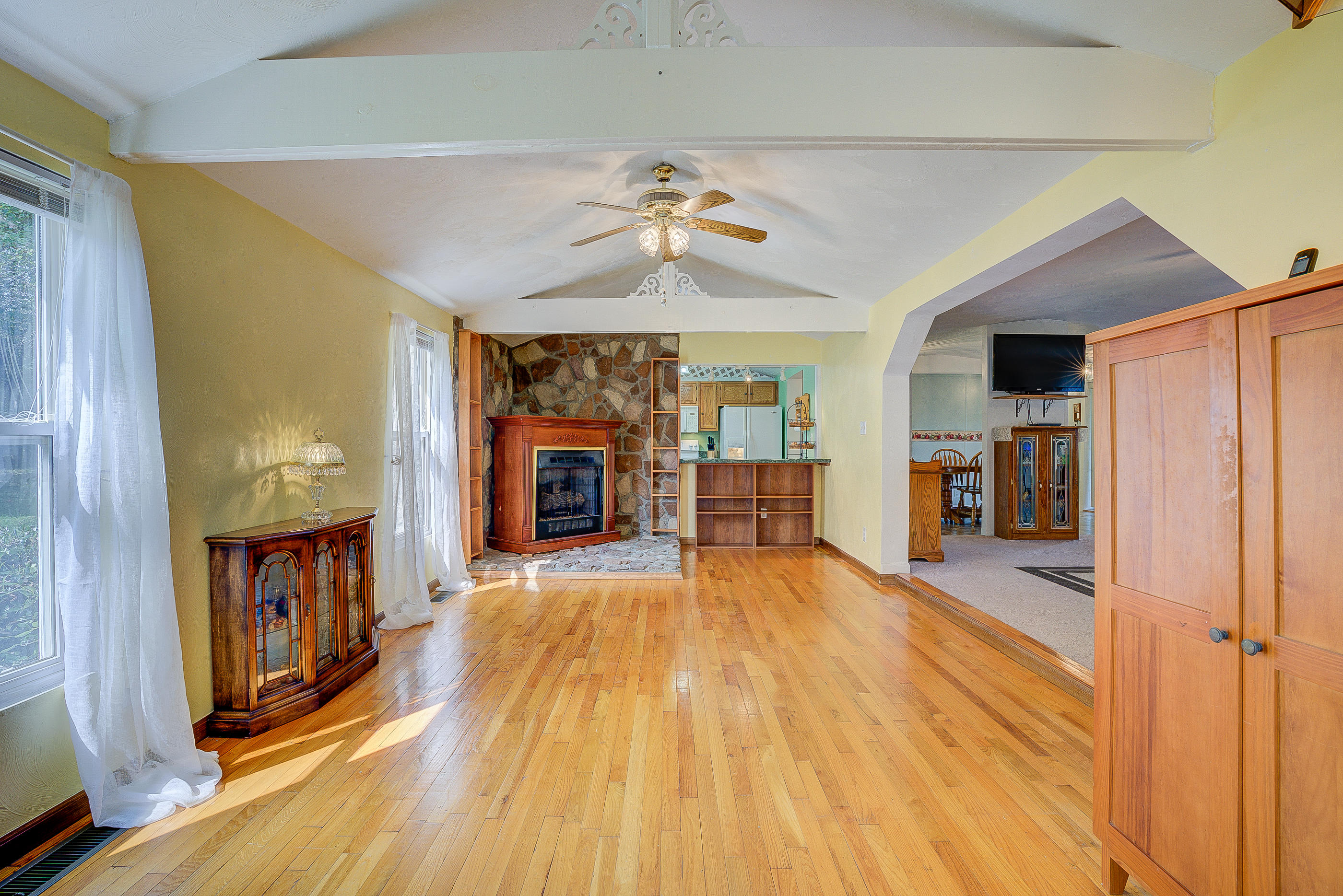 1133 Running Deer Ridge, Unit 1083 Goodview, VA 24095 - Photo 2 of 35 a view of an empty room with window fireplace and a chandelier fan