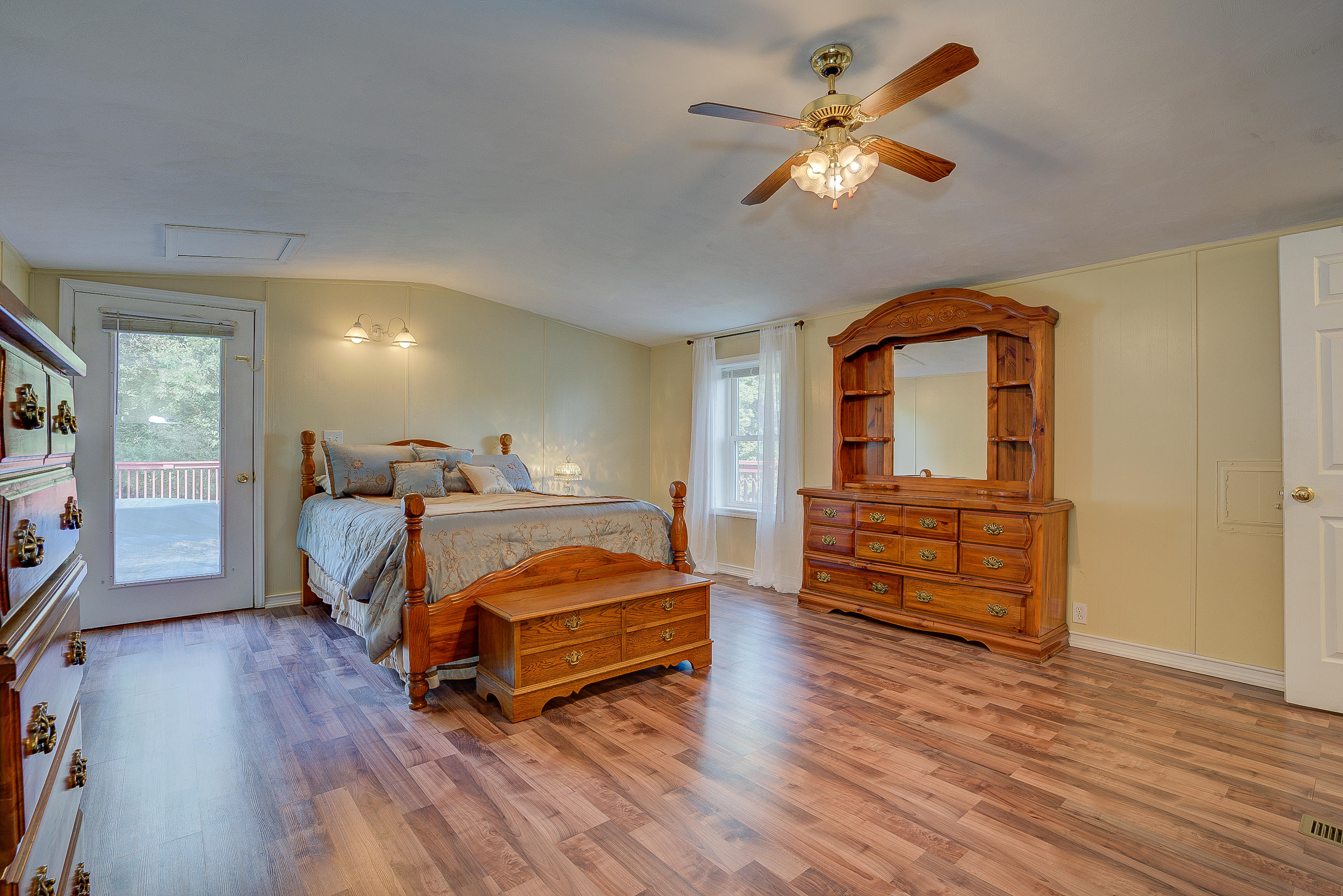1133 Running Deer Ridge, Unit 1083 Goodview, VA 24095 - Photo 13 of 35 a bedroom with a bed and wooden floor