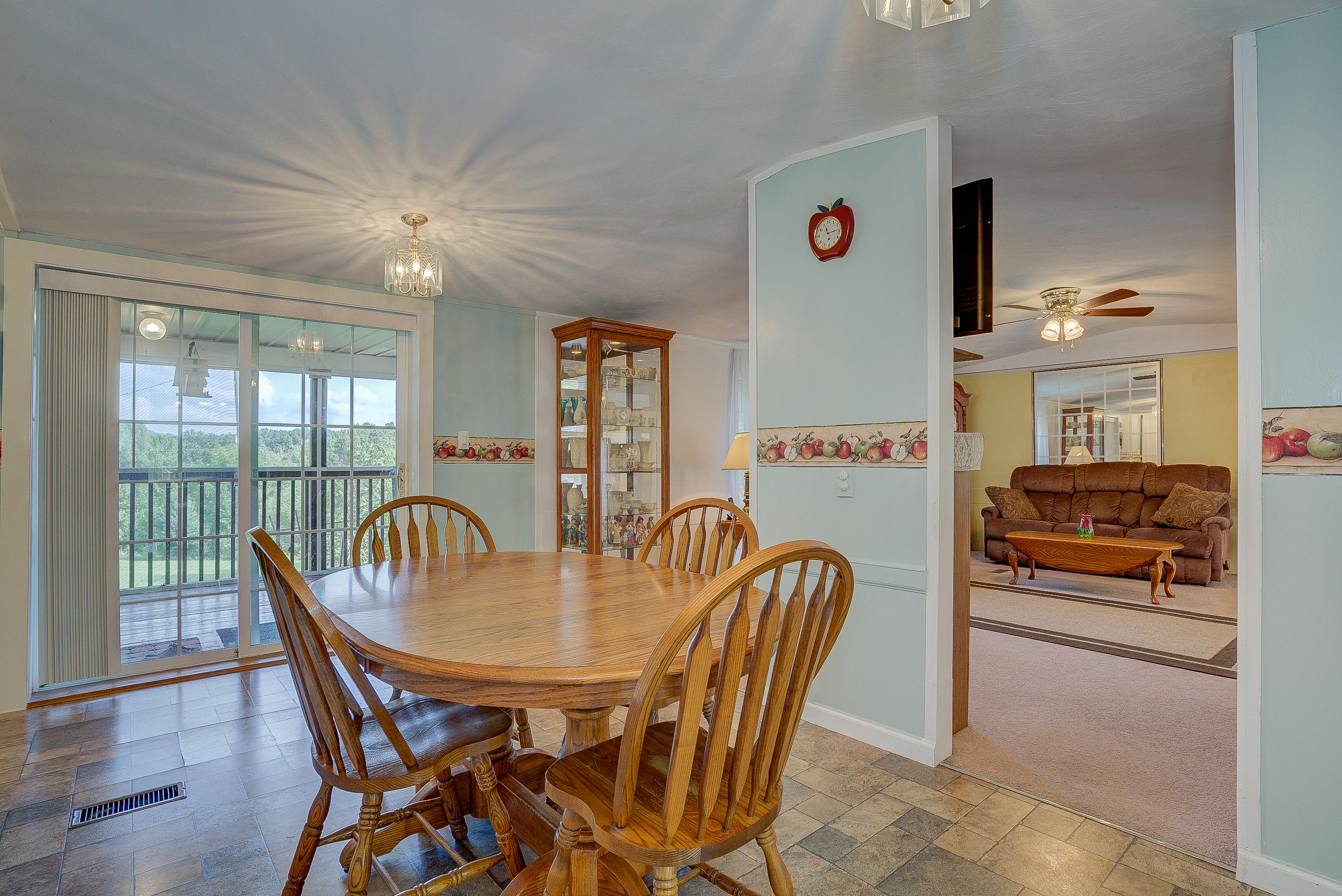 1133 Running Deer Ridge, Unit 1083 Goodview, VA 24095 - Photo 16 of 35 a dining room with furniture a chandelier and wooden floor
