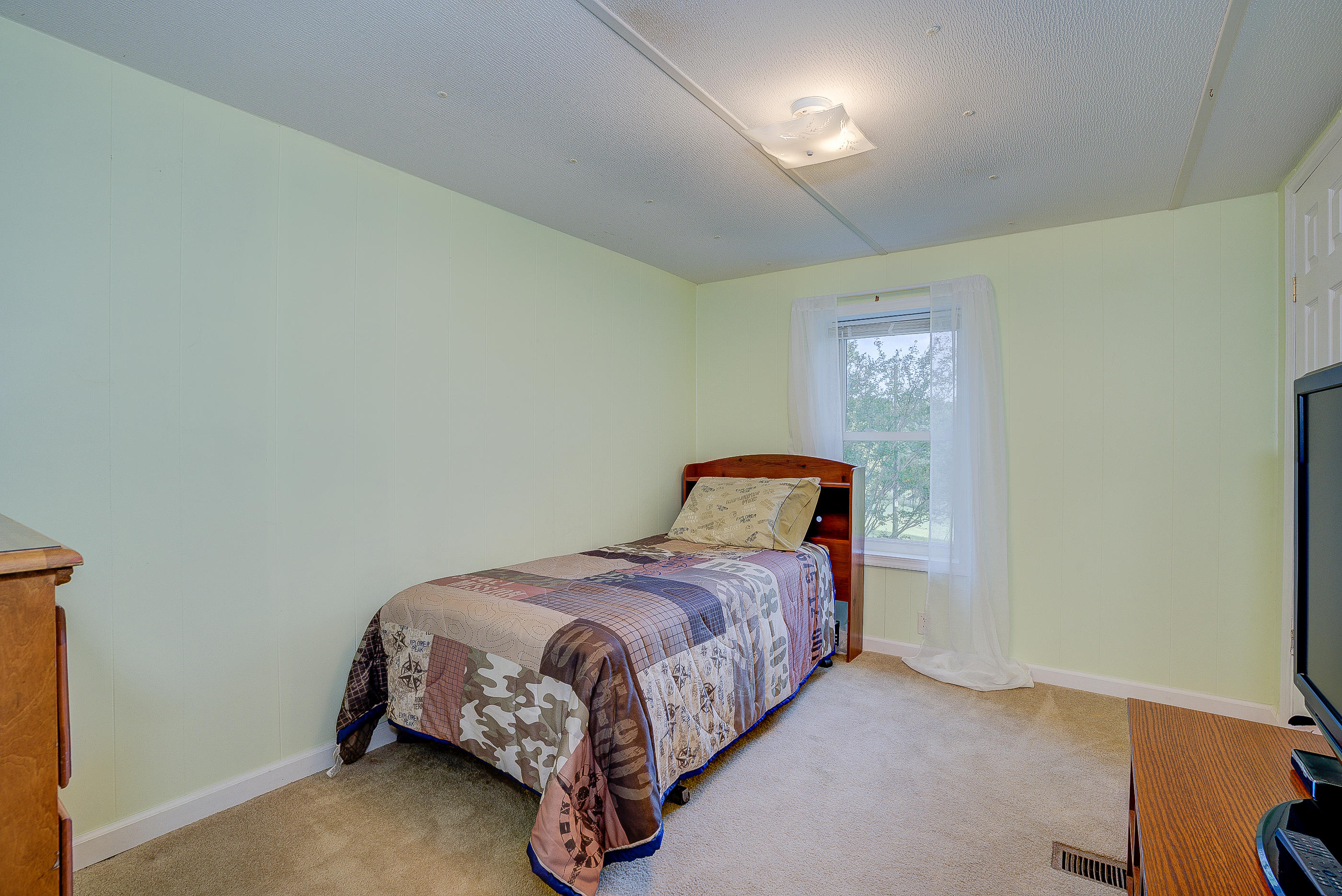 1133 Running Deer Ridge, Unit 1083 Goodview, VA 24095 - Photo 22 of 35 a bedroom with a bed and a night stand