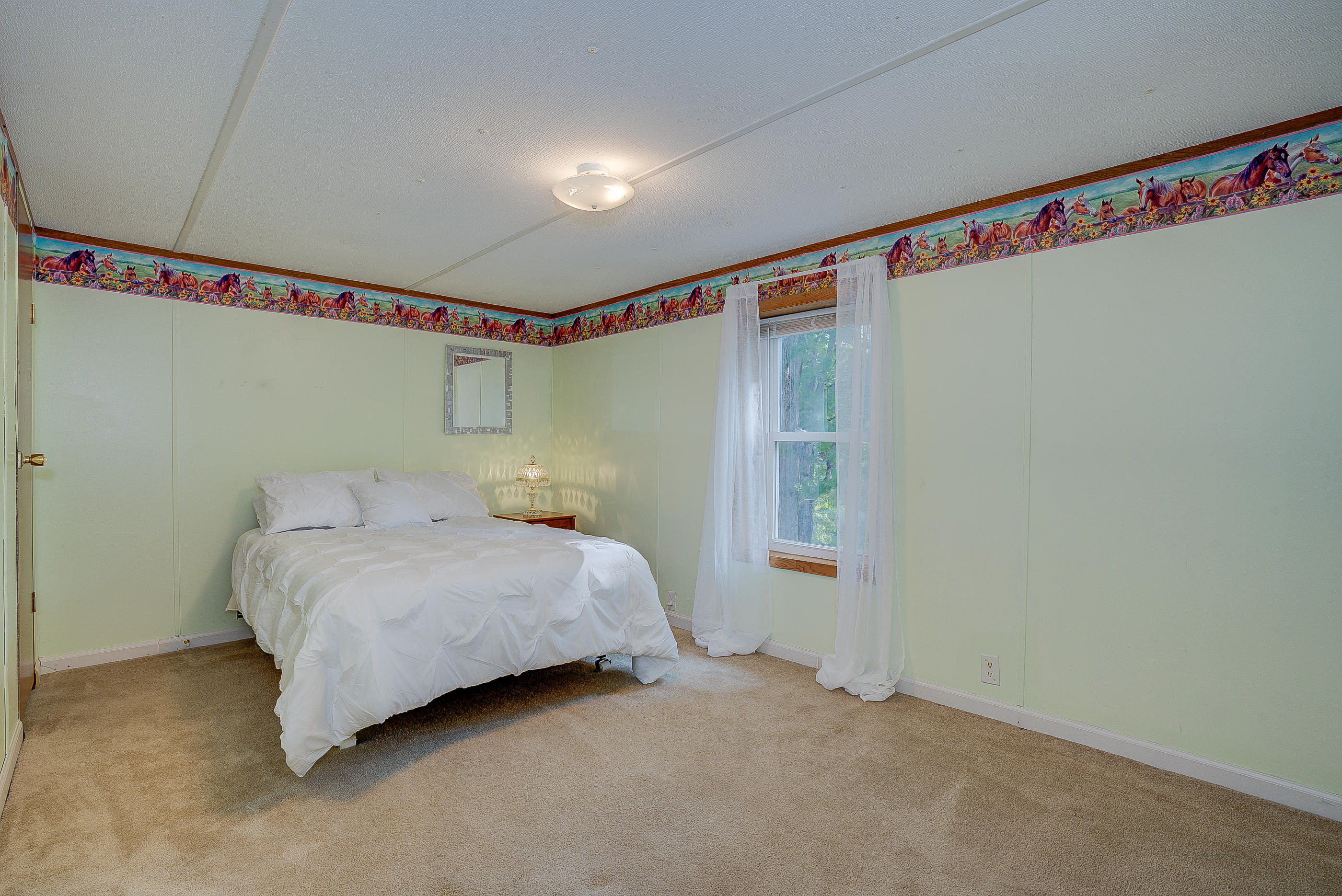 1133 Running Deer Ridge, Unit 1083 Goodview, VA 24095 - Photo 23 of 35 a bedroom with a bed and a window